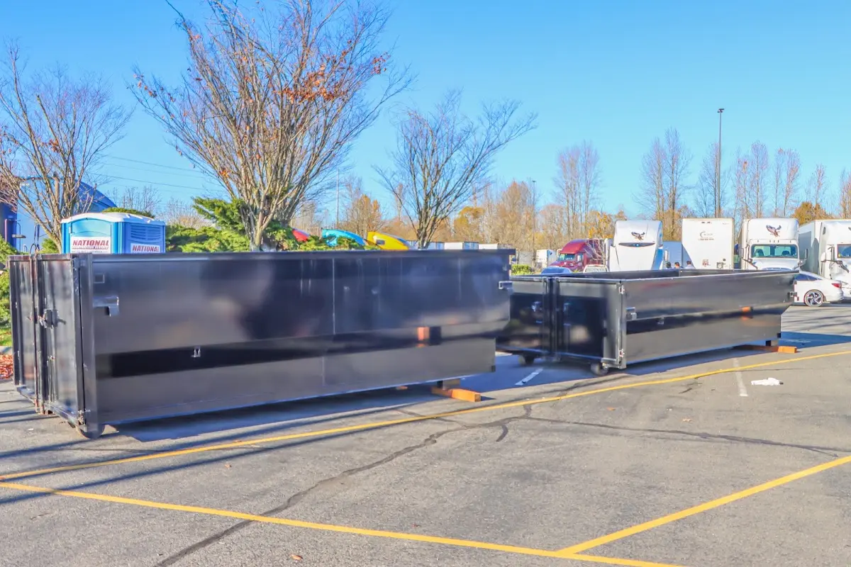 Professional dumpster rental service with roll-off container on residential driveway in Elon